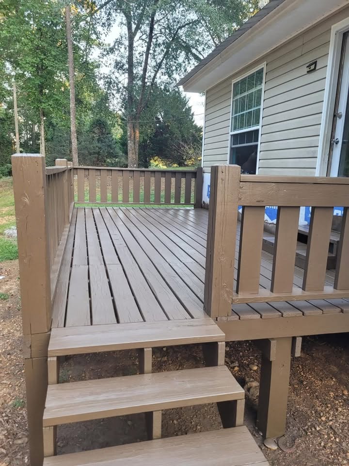 Completed raised porch deck with stairs, rails, and exterior siding