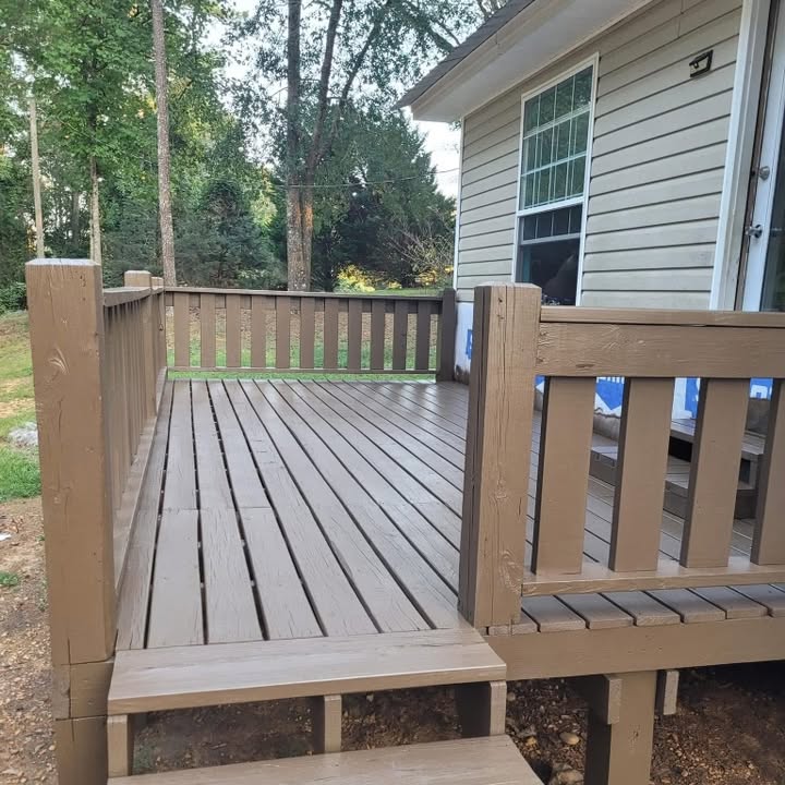 Finished residential deck with matching rail and stairs beside a home