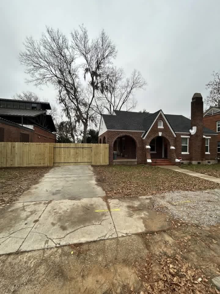Wooden privacy fence with a double driveway gate